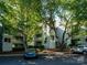Exterior view of a well-maintained residential building with lush trees in front at 233 Northwest Dr, Davidson, NC 28036