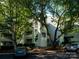 Stylish condo building with gray siding, mature trees, and well-maintained landscaping at 233 Northwest Dr, Davidson, NC 28036