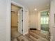Bright foyer with wood-look flooring, white trim, and open doorways to living spaces at 233 Northwest Dr, Davidson, NC 28036