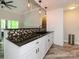 Kitchen features sleek black countertops, mosaic backsplash, and wood-look flooring at 233 Northwest Dr, Davidson, NC 28036