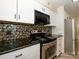 Kitchen featuring stainless steel appliances, white cabinets, and modern fixtures at 233 Northwest Dr, Davidson, NC 28036