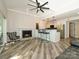 Open-concept living area with a fireplace, island seating, and modern pendant lighting at 233 Northwest Dr, Davidson, NC 28036