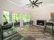Bright living room featuring vaulted ceilings, fireplace, and access to the outdoor balcony at 233 Northwest Dr, Davidson, NC 28036