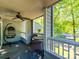 Relaxing porch featuring a hanging chair, ceiling fan, and beautiful waterfront views at 233 Northwest Dr, Davidson, NC 28036