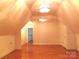 Spacious attic area with hardwood flooring and lighting at 2530 Sharon Rd, York, SC