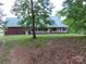 Spacious brick home with a large porch, surrounded by trees and a well-maintained lawn at 2530 Sharon Rd, York, SC
