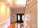 Elegant foyer with wood floors, staircase, and a double-door entry, highlighted by neutral walls and lighting at 2530 Sharon Rd, York, SC