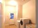 Functional laundry room with washer, dryer, and a door to the backyard at 2530 Sharon Rd, York, SC