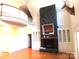 Spacious living room features a stone fireplace, hardwood floors, and built-in shelving at 2530 Sharon Rd, York, SC