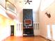 Bright living room with a stone fireplace, built-in cabinets, hardwood floors, and a balcony view at 2530 Sharon Rd, York, SC