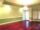 Spacious living room with hardwood floors, crown molding, and a chandelier at 2530 Sharon Rd, York, SC