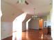 Large living room with hardwood floors, chandelier lighting, and plenty of windows at 2530 Sharon Rd, York, SC