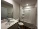 Well-lit bathroom featuring a shower-tub combo, white vanity with a sink, and a toilet at 2554 Goose Fair Rd, Maiden, NC 28650