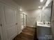 Bathroom featuring a glass enclosed shower, double sinks, white cabinetry and modern fixtures at 2554 Goose Fair Rd, Maiden, NC 28650