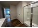 Bathroom featuring hardwood floors and a walk-in shower with built in seat at 2554 Goose Fair Rd, Maiden, NC 28650