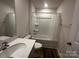 Compact bathroom featuring a tub with shower, single sink vanity, and toilet in a neutral color scheme at 2554 Goose Fair Rd, Maiden, NC 28650