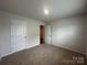 Clean bedroom with carpeting, featuring an open doorway and a double-door closet at 2554 Goose Fair Rd, Maiden, NC 28650