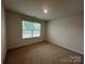 Bright bedroom with a window, carpet, and neutral paint creating a cozy and inviting space at 2554 Goose Fair Rd, Maiden, NC 28650
