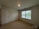 Bedroom featuring a window providing natural light, paired with neutral carpet and paint at 2554 Goose Fair Rd, Maiden, NC 28650