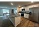 Modern kitchen boasts a large island, stainless steel appliances, granite countertops, and wood flooring at 2554 Goose Fair Rd, Maiden, NC 28650