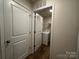 A bright laundry room features a washer and dryer, white door, and convenient overhead storage at 2554 Goose Fair Rd, Maiden, NC 28650