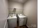 Laundry room features a new washer, dryer, wood floor, and wire shelving unit at 2554 Goose Fair Rd, Maiden, NC 28650
