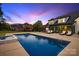 Backyard featuring pool, hot tub, backyard dining and lounge furniture at dusk at 2854 Harlinsdale Dr, Rock Hill, SC 29732