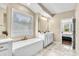 A bright bathroom with a soaking tub and a view of the bedroom at 2854 Harlinsdale Dr, Rock Hill, SC 29732