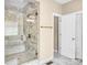 The renovated bathroom boasts a glass shower with marble tiling and gold accents at 2854 Harlinsdale Dr, Rock Hill, SC 29732