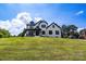 Charming home with a covered porch, dark trim, and a sprawling front lawn on a slight hill at 2854 Harlinsdale Dr, Rock Hill, SC 29732
