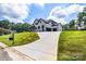 Beautiful home with long driveway leading to a three-car garage and manicured front lawn at 2854 Harlinsdale Dr, Rock Hill, SC 29732