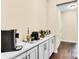 Hallway with white cabinets and white countertop displaying a modern coffee bar at 2854 Harlinsdale Dr, Rock Hill, SC 29732