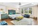 Luxurious main bedroom with tray ceiling, plush bed, sitting area and abundant natural light from large windows at 2854 Harlinsdale Dr, Rock Hill, SC 29732