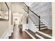 Elegant staircase with white railings, dark wood steps, and decorative wall paneling in the foyer at 2854 Harlinsdale Dr, Rock Hill, SC 29732