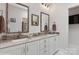 Bathroom with double sinks, framed mirrors, granite countertop and white cabinetry at 3006 Portico Pl # 37, Fort Mill, SC 29715
