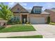 Beautiful brick home with lush lawn, manicured landscaping and attached two-car garage at 3006 Portico Pl # 37, Fort Mill, SC 29715
