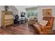 Bright living room featuring hardwood floors, a comfortable chair, and modern decor at 3006 Portico Pl # 37, Fort Mill, SC 29715