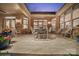 Beautifully designed patio with brick surround, tile floor, and ample seating perfect for outdoor entertaining at 3006 Portico Pl # 37, Fort Mill, SC 29715