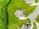 Bird's-eye view of the property featuring a well-manicured lawn, mature trees, and a long driveway leading to the home at 308 Hollister Estates Dr, Waxhaw, NC 28173