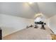 Large attic space with carpet, windows, bench, fan, and workout equipment at 308 Hollister Estates Dr, Waxhaw, NC 28173