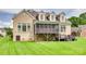 The rear of the home showcases a large, well-maintained yard with a screened porch and a brick exterior at 308 Hollister Estates Dr, Waxhaw, NC 28173