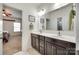 Bright bathroom featuring a double vanity with mirror and access to the bedroom at 308 Hollister Estates Dr, Waxhaw, NC 28173