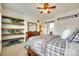Neutral bedroom with open shelves, wood floors, and a ceiling fan with integrated lighting at 308 Hollister Estates Dr, Waxhaw, NC 28173