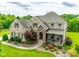 Aerial view of a brick home with manicured landscaping and a inviting front porch at 308 Hollister Estates Dr, Waxhaw, NC 28173