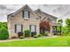 Attractive brick home features manicured landscaping, and covered porch at 308 Hollister Estates Dr, Waxhaw, NC 28173