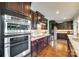 Gourmet kitchen with stainless steel appliances, granite countertops, and dark wood cabinets at 308 Hollister Estates Dr, Waxhaw, NC 28173