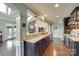 Open-concept kitchen with granite countertops, hardwood floors, and stainless steel appliances at 308 Hollister Estates Dr, Waxhaw, NC 28173