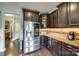 Gourmet kitchen with stainless steel refrigerator and dark wood cabinetry at 308 Hollister Estates Dr, Waxhaw, NC 28173