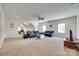 Large living room with carpeted floors, fan, windows, and furniture at 308 Hollister Estates Dr, Waxhaw, NC 28173