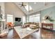 Bright living room with vaulted ceilings, large windows, fireplace, and hardwood floors at 308 Hollister Estates Dr, Waxhaw, NC 28173